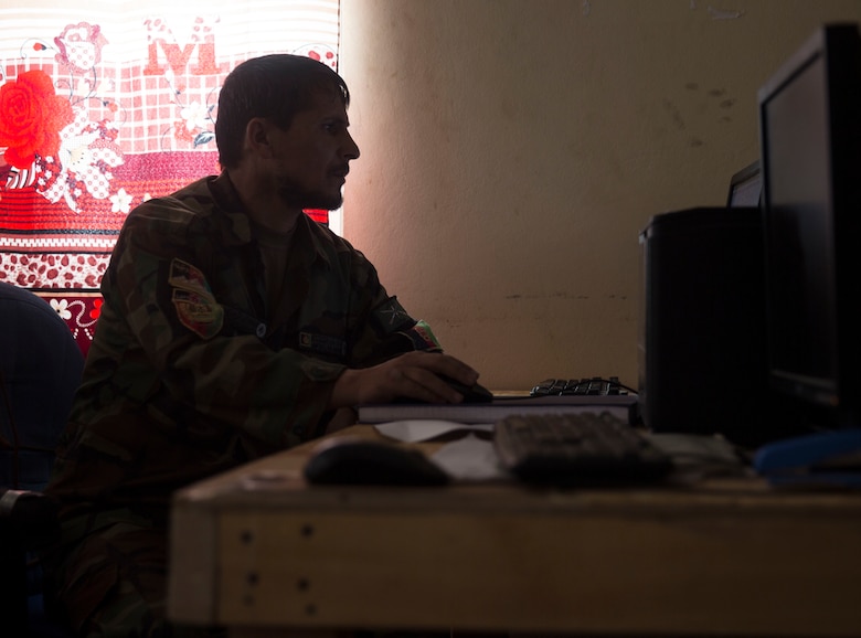 An Afghan National Defense and Security Force policeman verifies information passed to the Operational Coordination Center – Regional at Bost Airfield, Afghanistan, Oct. 3, 2017. One of the primary missions of the Operational Coordination Center - Regional is to maintain situational awareness with operational forces on the ground and provide information to ground commanders so they can manage their forces and resources effectively. (U.S. Marine Corps photo by Sgt. Justin T. Updegraff)