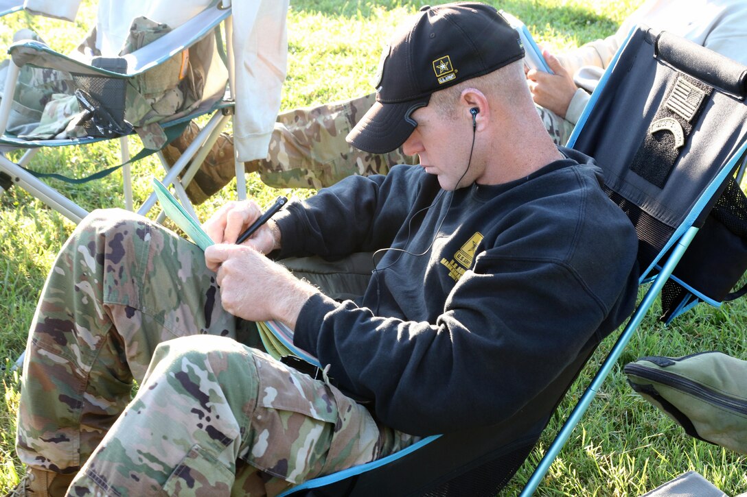 Soldier takes notes during marksmanship competition.