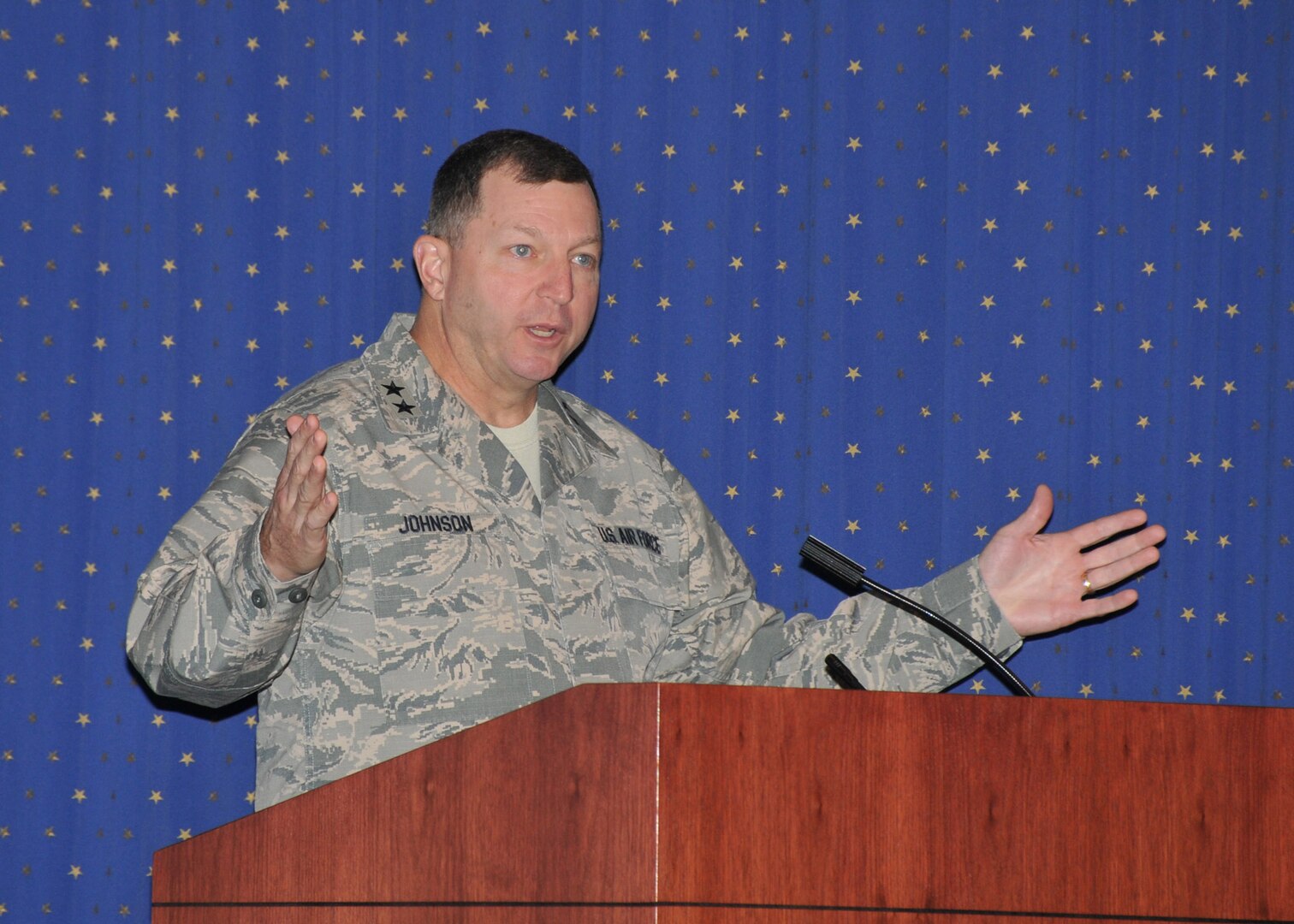 Two-star AF general speaking at lecturn.
