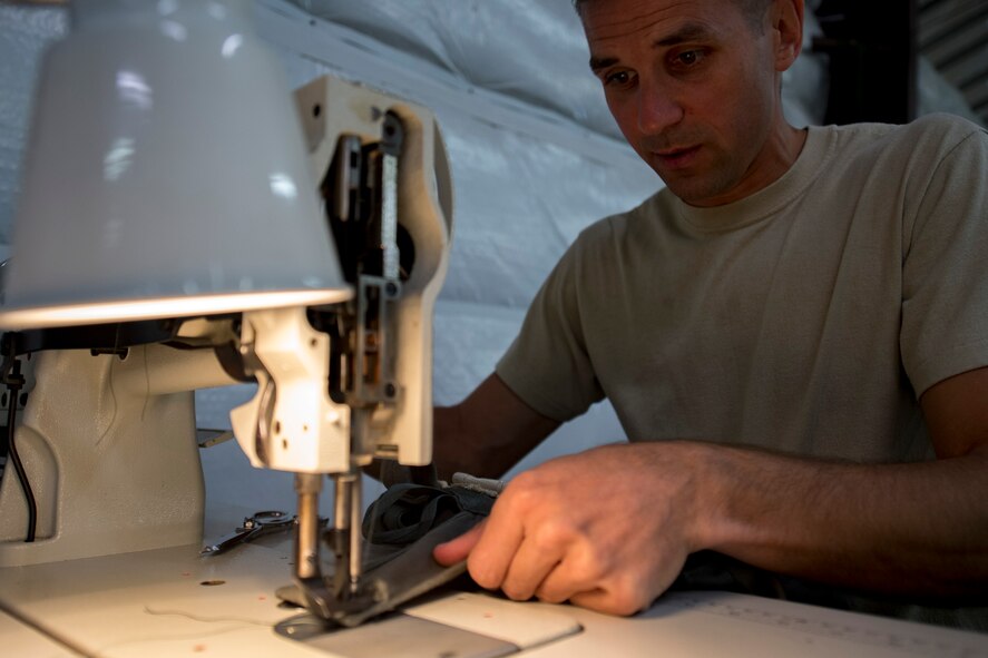 U.S. Air Force Tech. Sgt. John Schmidt, 820th Combat Operations Squadron (COS) NCO in charge of aircrew flight equipment, corrects a deficiency to an MC-6 parachute deployment bag, Oct. 4, 2017, at Moody Air Force Base, Ga. The 820th COS’s four-person shop of parachute riggers are responsible for ensuring every 820th Base Defense Group parachute is serviceable, while also ensuring ground safety at the drop zone. The team has packed and inspected more than 490 parachutes in 2017. (U.S. Air Force photo by Airman 1st Class Daniel Snider)