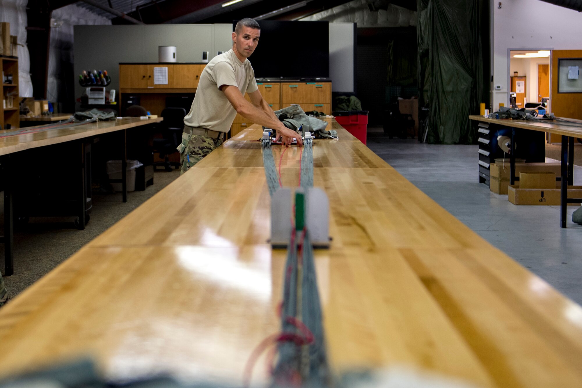 U.S. Air Force Tech. Sgt. John Schmidt, 820th Combat Operations Squadron (COS) NCO in charge of aircrew flight equipment, ensures an MC-6 parachutes lines’ serviceability, Oct. 4, 2017, at Moody Air Force Base, Ga. The 820th COS’s four-person shop of parachute riggers are responsible for ensuring every 820th Base Defense Group parachute is serviceable, while also ensuring ground safety at the drop zone. The team has packed and inspected more than 490 parachutes in 2017. (U.S. Air Force photo by Airman 1st Class Daniel Snider)