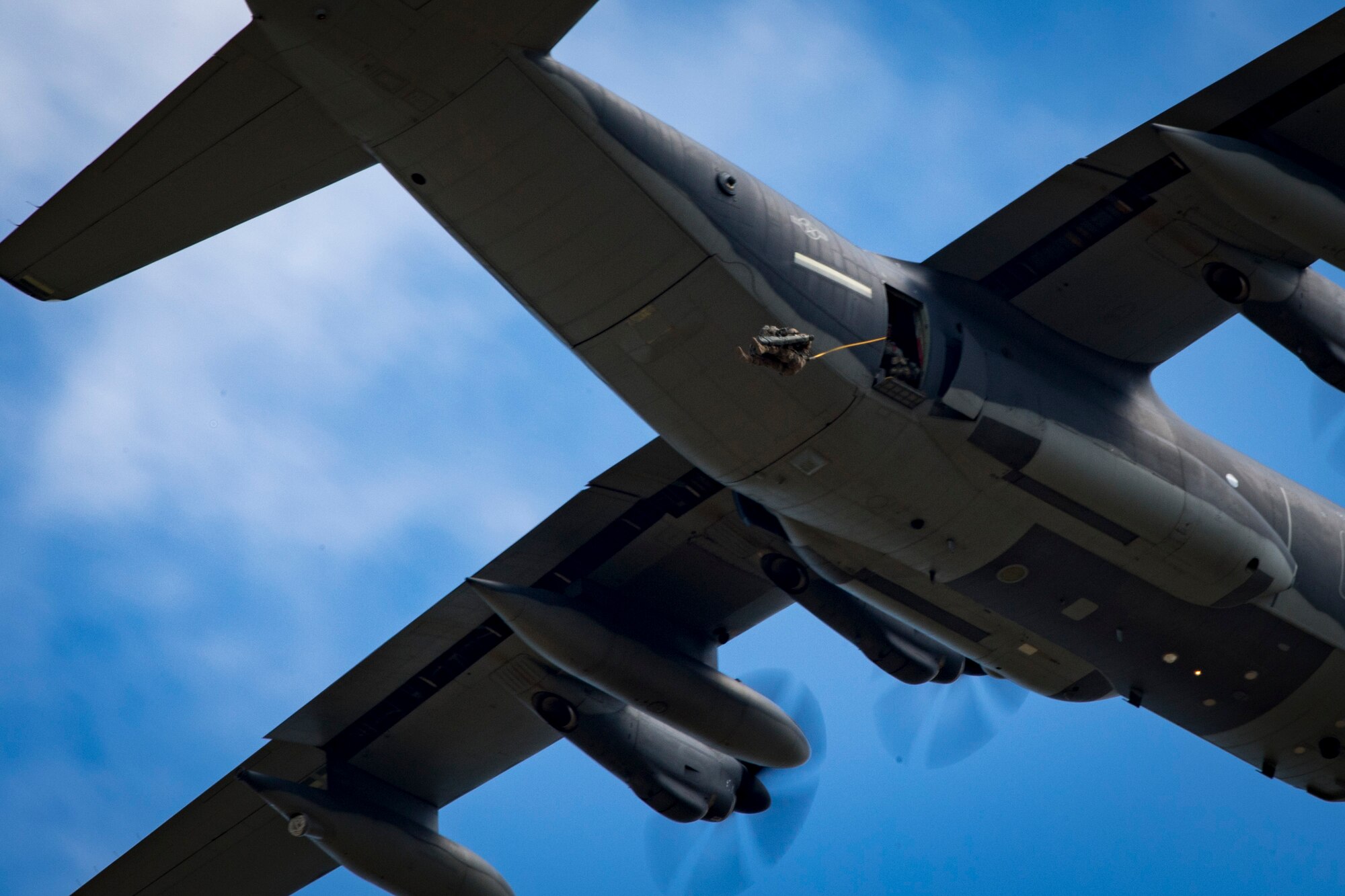 A member of the 820th Base Defense Group (BDG) exits an HC-130J Combat King II during a static-line jump, Oct. 3, 2017, at the Lee Fulp drop zone in Tifton, Ga. The 820th Combat Operations Squadron’s four-person shop of parachute riggers are responsible for ensuring every 820th BDG parachute is serviceable, while also ensuring ground safety at the drop zone. The team has packed and inspected more than 490 parachutes in 2017. (U.S. Air Force photo by Airman 1st Class Daniel Snider)
