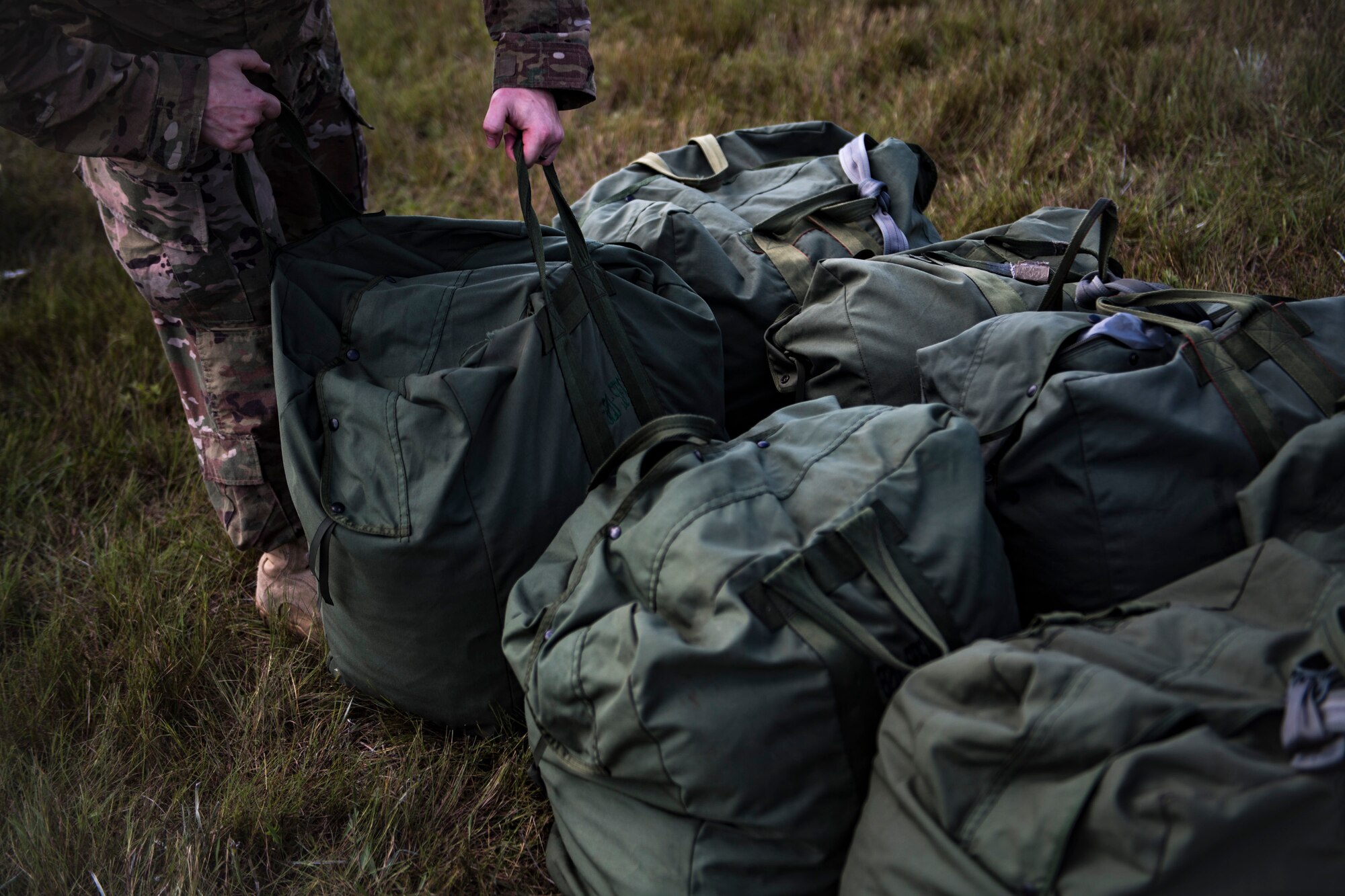 A member of the 820th Base Defense Group (BDG) adds an MC-6 parachute into formation for accountability, Oct. 3, 2017, at the Lee Fulp drop zone in Tifton, Ga. The 820th Combat Operations Squadron’s four-person shop of parachute riggers are responsible for ensuring every 820th BDG parachute is serviceable, while also ensuring ground safety at the drop zone. The team has packed and inspected more than 490 parachutes in 2017. (U.S. Air Force photo by Airman 1st Class Daniel Snider)