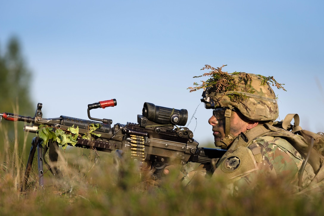 A soldier scans his sector of fire while providing security and participating in the Polish national defensive exercise, Dragon 17.