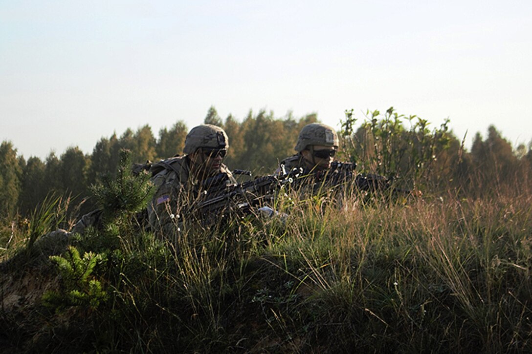 Soldiers provide security from their defensive fighting position participating in the Polish national defensive exercise, Dragon 17.
