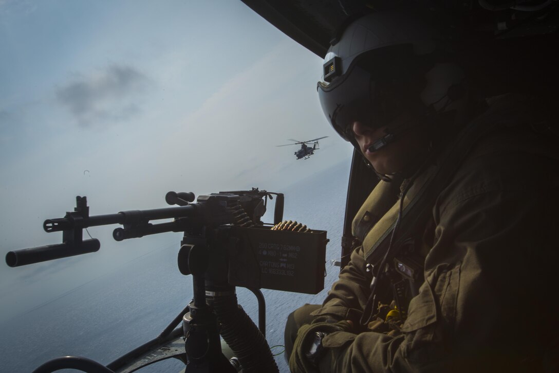 A crew chief with Marine Light Attack Helicopter Squadron 169 observes the ocean while sitting in a UH-1Y Venom over Okinawa, Japan, September 28, 2017. The squadron conducted aerial live-fire training in Okinawa, which is crucial to maintaining a stronger, more capable, forward deployed force in the Indo-Asia-Pacific region. The aircraft is assigned to HMLA-169, Marine Aircraft Group 39, 3rd Marine Aircraft Wing, currently forward deployed under the unit deployment program with MAG-36, 1st MAW.