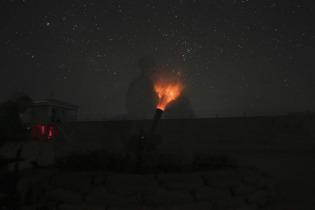 An illumination round from an 81mm mortar lights up against a night sky.