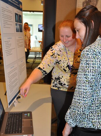 IMAGE: DAHLGREN, Va. (Sept. 29) - NSWC Dahlgren Division computer scientist Teeya Roche and software lead Megan Kozub explain "Data Visualization Support for Creation of a Numerical Table: Effects on Training and Performance" at the In-House Laboratory Independent Research and Independent Applied Research review. The study was designed to test principles of data visualization to decrease the information processing assessment time for decision-making; increase understanding of visual-based doctrine, and reduce incorrect doctrine creation.