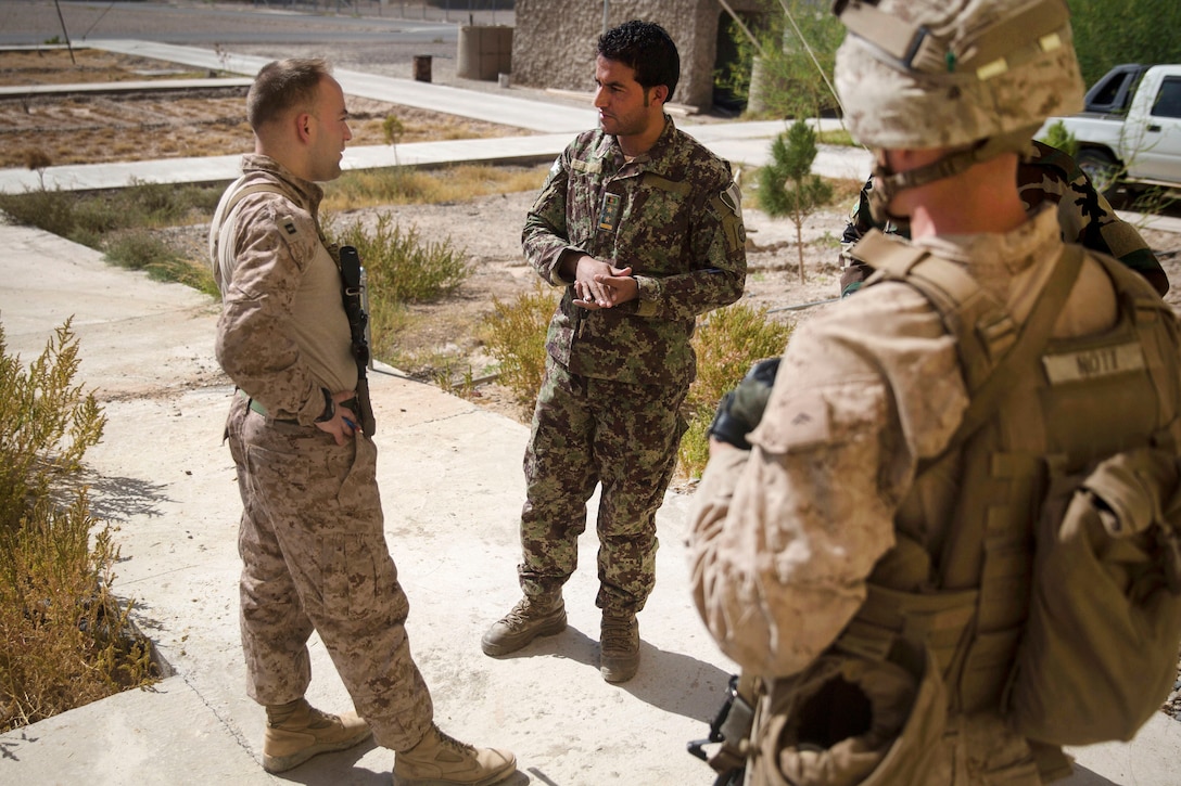 A U.S. Marine advisor with Task Force Southwest meets with Afghan army leader at 1st Brigade headquarter.