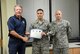 Airman 1st Class Adam Khrais, with the 552nd Maintenance Group, is presented his Diamond Sharp Award by the 15th Chief Master Sgt. of the Air Force Rodney McKinley and his first sergeant, Master Sgt. Paul Barentine.