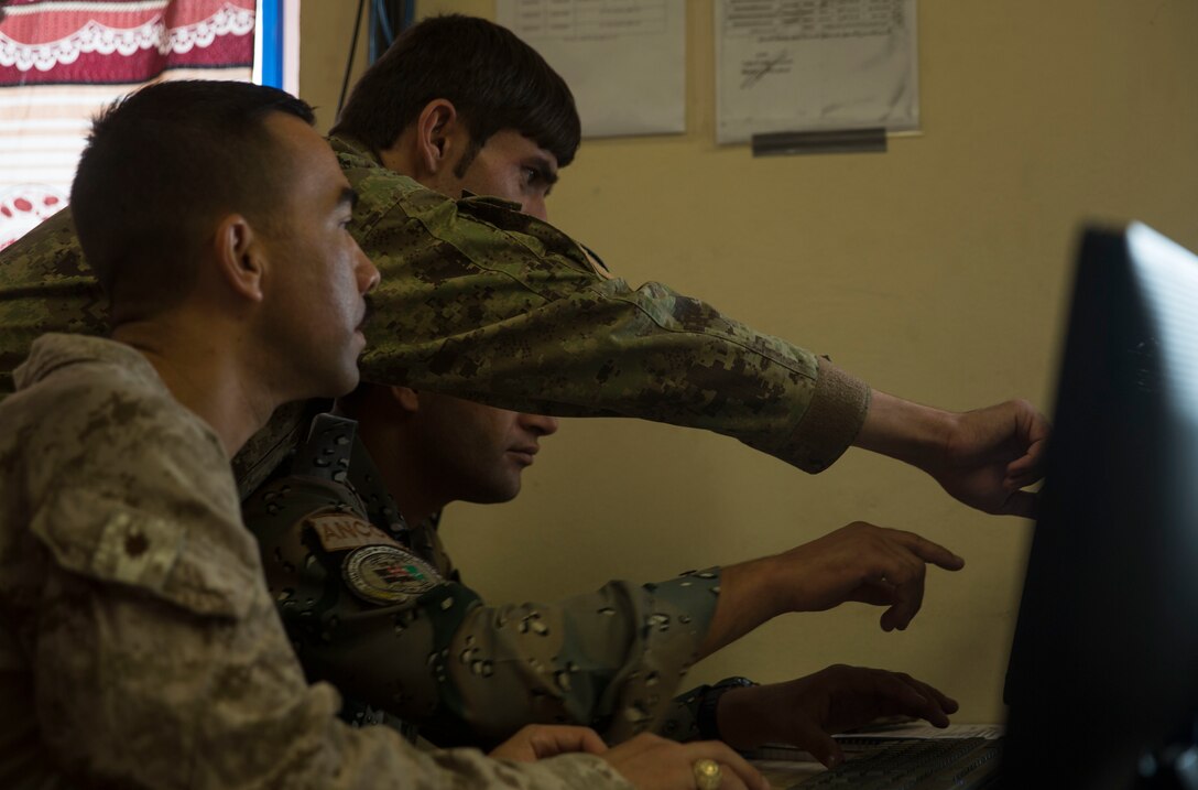 A U.S. Marine advisor with Task Force Southwest and Afghan National Defense and Security Force policemen work through an issue at the Operational Coordination Center – Regional at Bost Airfield, Afghanistan, Oct. 2, 2017. One of the primary missions of the OCC-R is to maintain situational awareness with operational forces on the ground and provide information to ground commanders so they can manage their forces and resources effectively. (U.S. Marine Corps photo by Sgt. Justin T. Updegraff)