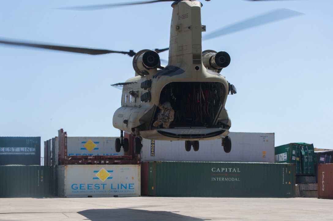 U.S. Army Sgt. Arthur W. Hinkle, a flight engineer with Joint Task Force - Leeward Islands, watches from the back of a U.S. Army CH-47 Chinook helicopter as the aircraft departs from the port of Roseau, Dominica, Oct. 3, 2017. The aircraft delivered rice and kitchen sets from the U.S. Agency of International Development for delivery to the community of Wotten Waven, Dominica. At the request of USAID, JTF-LI has deployed aircraft and service members to assist in delivering relief supplies to Dominica in the aftermath of Hurricane Maria. The task force is a U.S. military unit composed of Marines, Soldiers, Sailors and Airmen, and represents U.S. Southern Command’s primary response to the hurricanes that have affected the eastern Caribbean.