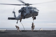 U.S. Marines with Fox Company, 2nd Battalion, 1st Marine Regiment and the Maritime Raid Force with the 13th Marine Expeditionary Unit, fast rope from a CH-60 Seahawk with Helicopter Sea Combat Squadron 23 aboard the USS Boxer off the coast of southern California during their Sustainment Exercise Jan. 17, 2016. SUSTEX is designed to reinforce the Boxer Amphibious Ready Group/MEU's execution of mission essential tasks in preparation for their upcoming deployment.