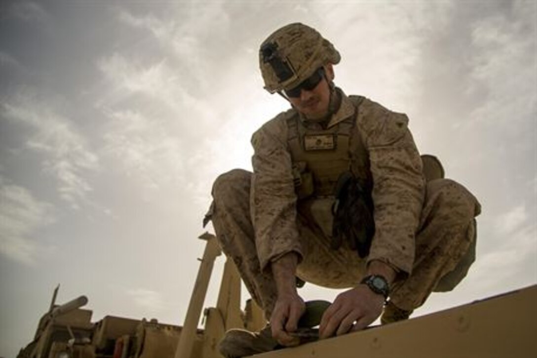 U.S. Marine Corps Cpl. Nicholas Orbik, engineer with Special Purpose Marine Air-Ground Task Force-Crisis Response-Central Command, prepares a truck to transport Alaskan barriers at Al Taqaddum Air Base, Iraq, Jan. 8, 2016. The 12-ton barriers are placed around structures to reinforce them and provide protection from shrapnel. Advise and assist sites, like Al Taqqadum Air Base, are an integral part of Combined Joint Task Force – Operation Inherent Resolve’s multinational effort to increase the military capacity of Iraqi Security Force personnel to defeat the Islamic State of Iraq and the Levant.