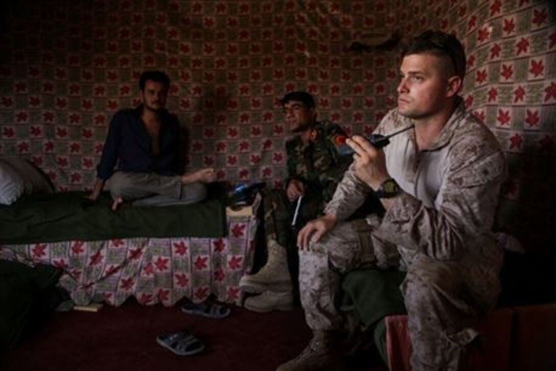 U.S. Marine Maj. Sean Kaiser, a communications advisor with Task Force Southwest, helps track troop movements with Afghan National Army soldiers from 215th Corps during Operation Maiwand Five near Nawa, Afghanistan, Aug. 19, 2017. Various elements of the Afghan National Defense and Security Forces, including the ANA, Afghan National Police and Afghan Border Police are clearing the Nawa area of enemy presence with assistance from Task Force advisors.