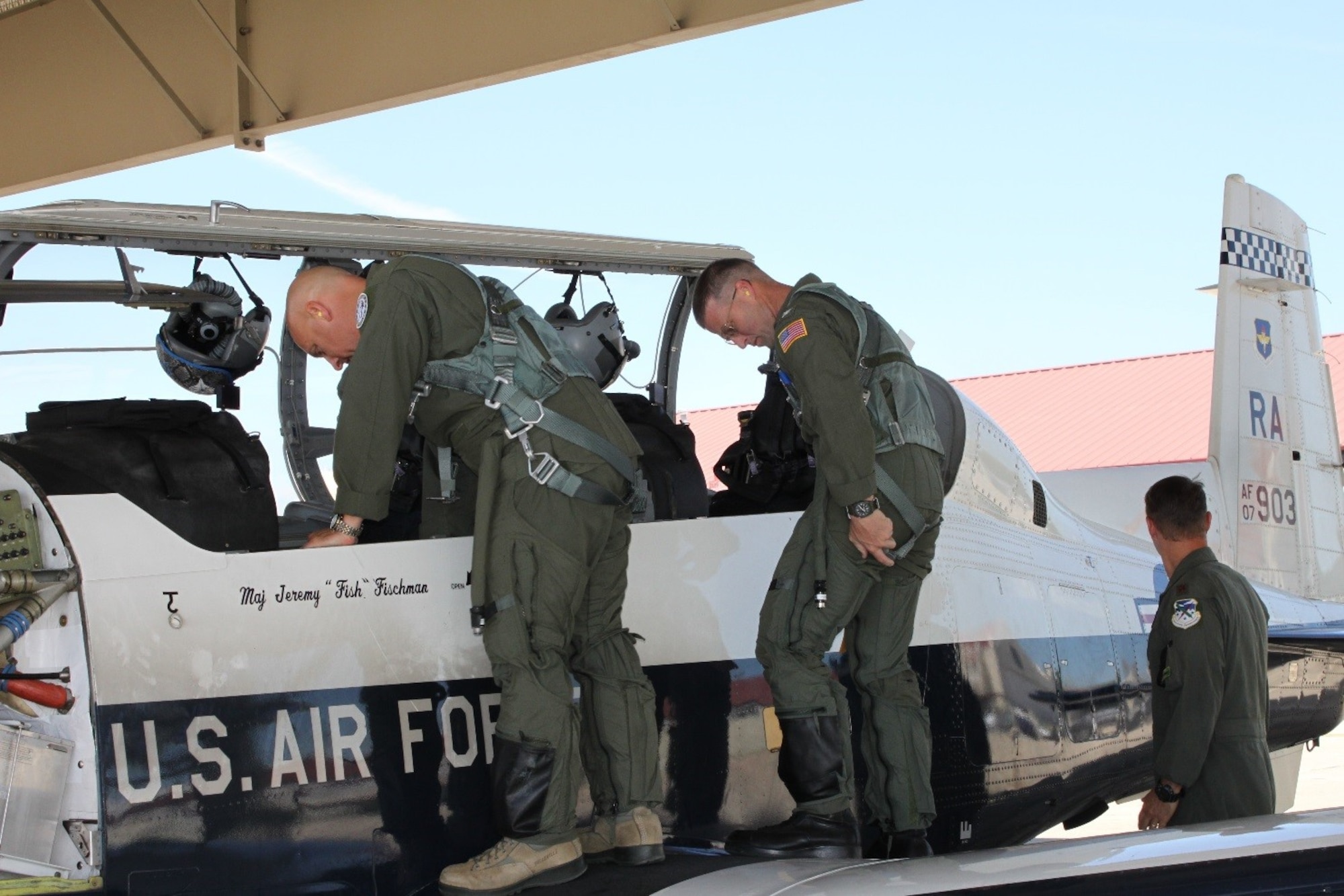 CUTLINE: Lt. Col. Andrew Kissinger (left) and U.S. Coast Guard Capt. Tony Hahn prepare to board the T-6 Texan II. The USCG Corpus Christi sector commander/air station commanding officer reached out to the 39th Flying Training Squadron to discuss pilot retention/recruiting and reserve integration benefits. Closing out his visit, Kissinger took him on a familiarization flight. (Photo by Debbie Gildea, 340th Flying Training Group Public Affairs).