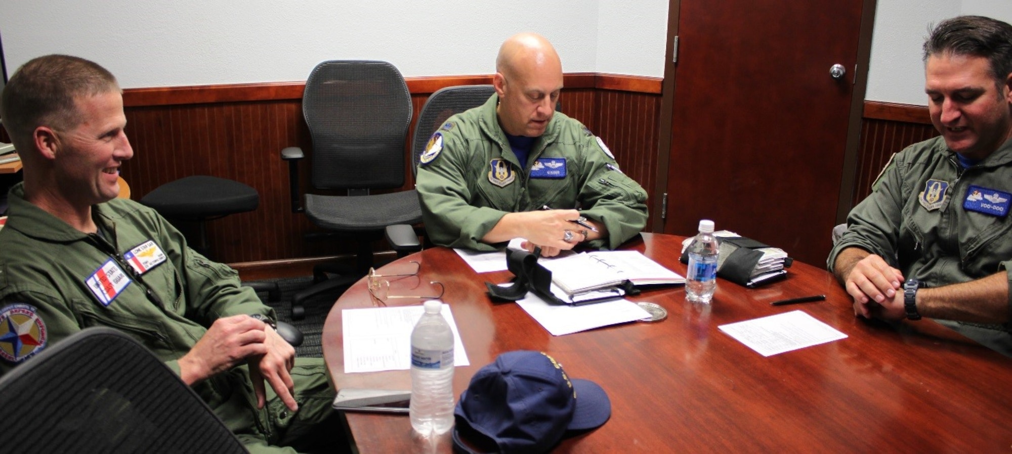 CUTLINE: Lt. Col. Andrew Kissinger (center) and Maj. Andrew Van De Walle (right), 39th Flying Training Squadron, prepare for a familiarization flight for visiting U.S. Coast Guard Commander Capt. Tony Hahn (left). The USCG Corpus Christi sector commander/air station commanding officer reached out to the 39th FTG to discuss pilot retention/recruiting and reserve integration benefits. (Photo by Debbie Gildea, 340th Flying Training Group Public Affairs).