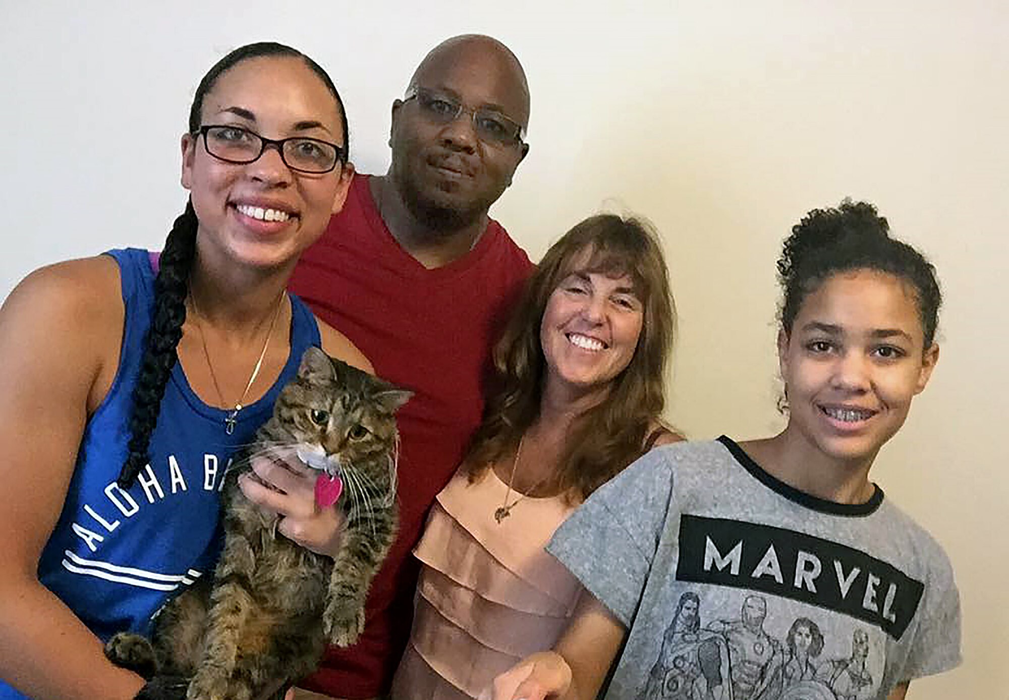 U.S. Air Force Senior Airman Jasmine Deauvearo, far left, a 509th Security Forces Squadron (SFS) armorer, takes a family photo with her father, Clarence, mother, Darla, sister, Janae, and her cat in Knob Noster, Mo., Fall 2016.