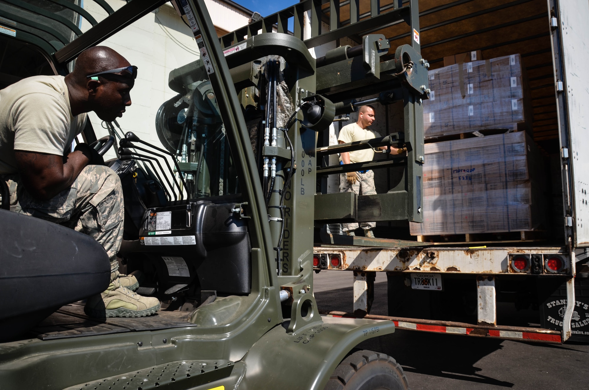Staff Sgt. Kens Germain, an aerial porter from Joint Base McGuire-Dix-Lakehurst, New Jersey, positions a forklift to pick up a stack of ready-to-eat meals at Dobbins Air Reserve Base, Ga., Oct. 4. A total of 23,390 pounds of food and water will be transported to Puerto Rico and distributed to those in need. (U.S. Air Force photo by Tech. Sgt. Kelly Goonan)