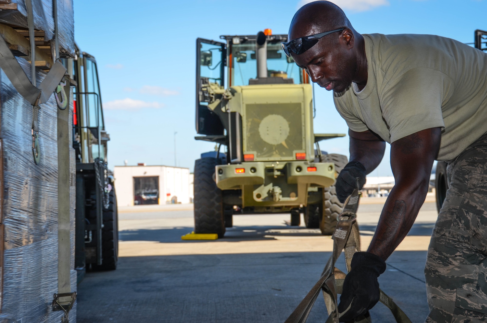 Staff Sgt. Kens Germain, an aerial porter from Joint Base McGuire-Dix-Lakehurst, New Jersey, straps down a stack of meals ready-to-eat at Dobbins Air Reserve Base, Ga., on Oct. 4. A total of 23,390 pounds of food and water will be transported to Puerto Rico and distributed to those in need. (U.S. Air Force photo by Tech. Sgt. Kelly Goonan)