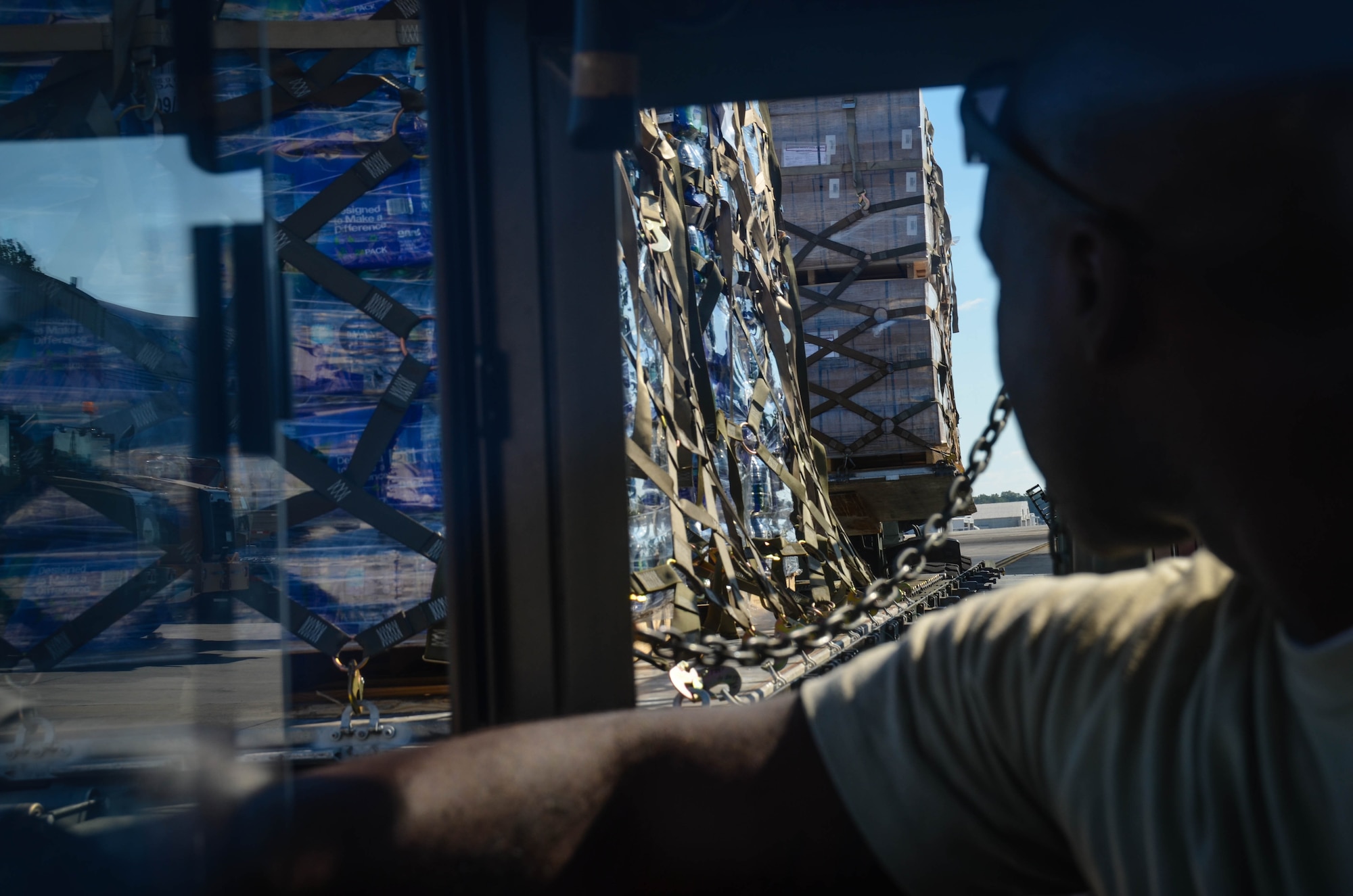 Staff Sgt. Kens Germain, an aerial porter from Joint Base McGuire-Dix-Lakehurst, New Jersey, watches as three pallets of water and meals ready-to-eat are loaded onto a K-loader at Dobbins Air Reserve Base, Ga. Oct. 4. A total of 23,390 pounds of food and water will be transported to Puerto Rico and distributed to those in need. (U.S. Air Force photo by Tech. Sgt. Kelly Goonan)