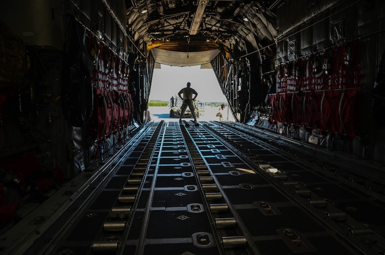 Airmen position a K-loader carrying water and ready-to-eat meals behind a C-130 Hercules at Dobbins Air Reserve Base, Ga. Oct. 4. Airmen loaded a Mansfield Air National Guard C-130 with a total of 23,390 pounds of food and water which will be transported to Puerto Rico and distributed to those in need. (U.S. Air Force photo by Tech. Sgt. Kelly Goonan)