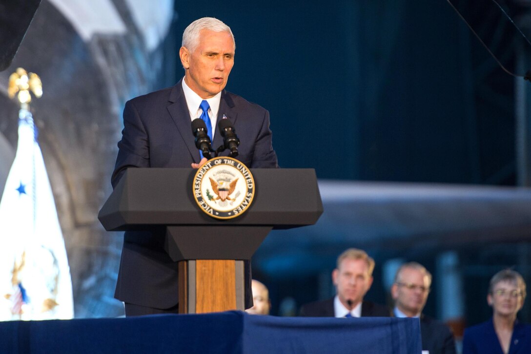 The vice president stands behind a podium on stage.