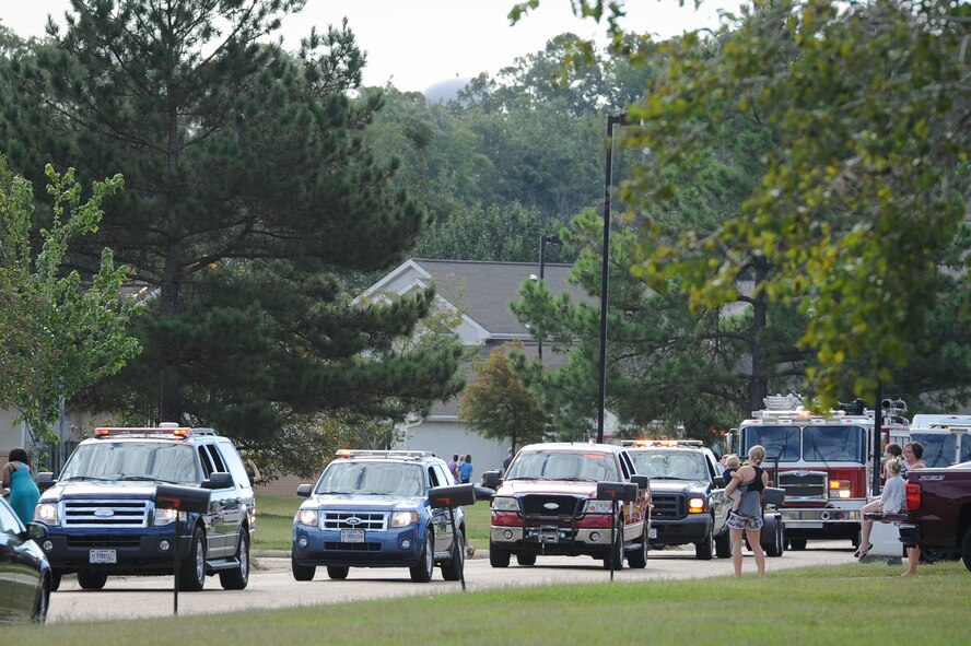 Representatives from fire departments on Columbus Air Force Base, Mississippi, and the surrounding communities, make their way through Magnolia Village housing Sept. 30, 2017, as part of a parade for Fire Prevention Week. Members of the Columbus AFB Fire Department planned a week full of fire prevention events from Sept. 25-30; some the events included talking to students in elementary schools, and fire extinguisher training. (U.S. Air Force photo by Staff Sgt. Christopher Gross)