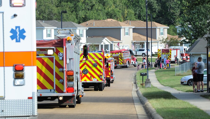 Families watch the different fire trucks pass by Sept. 30, 2017, in Magnolia Village on Columbus Air Force Base, Mississippi, and the surrounding communities. The trucks and vehicles, from Columbus AFB and surrounding communities’ fire departments, participated in a parade as part Fire Prevention Week. (U.S. Air Force photo by Staff Sgt. Christopher Gross)
