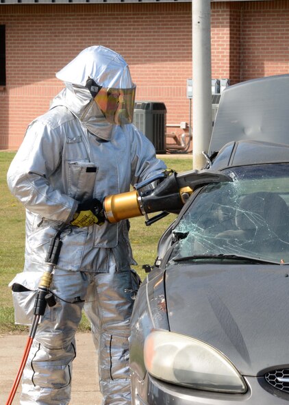 Senior Airman Ryan Offerman, 14th Civil Engineer Squadron firefighter, uses a power tool to cut up a vehicle for a live rescue demonstration Sept. 30, 2017, on Columbus Air Force Base, Mississippi. The demonstration simulated an accident that involved texting while driving and showed how the firefighters have to rescue the victim. The event was part of Fire Prevention Week Sept. 25-30. (U.S. Air Force photo by Airman 1st Class Beaux Hebert)