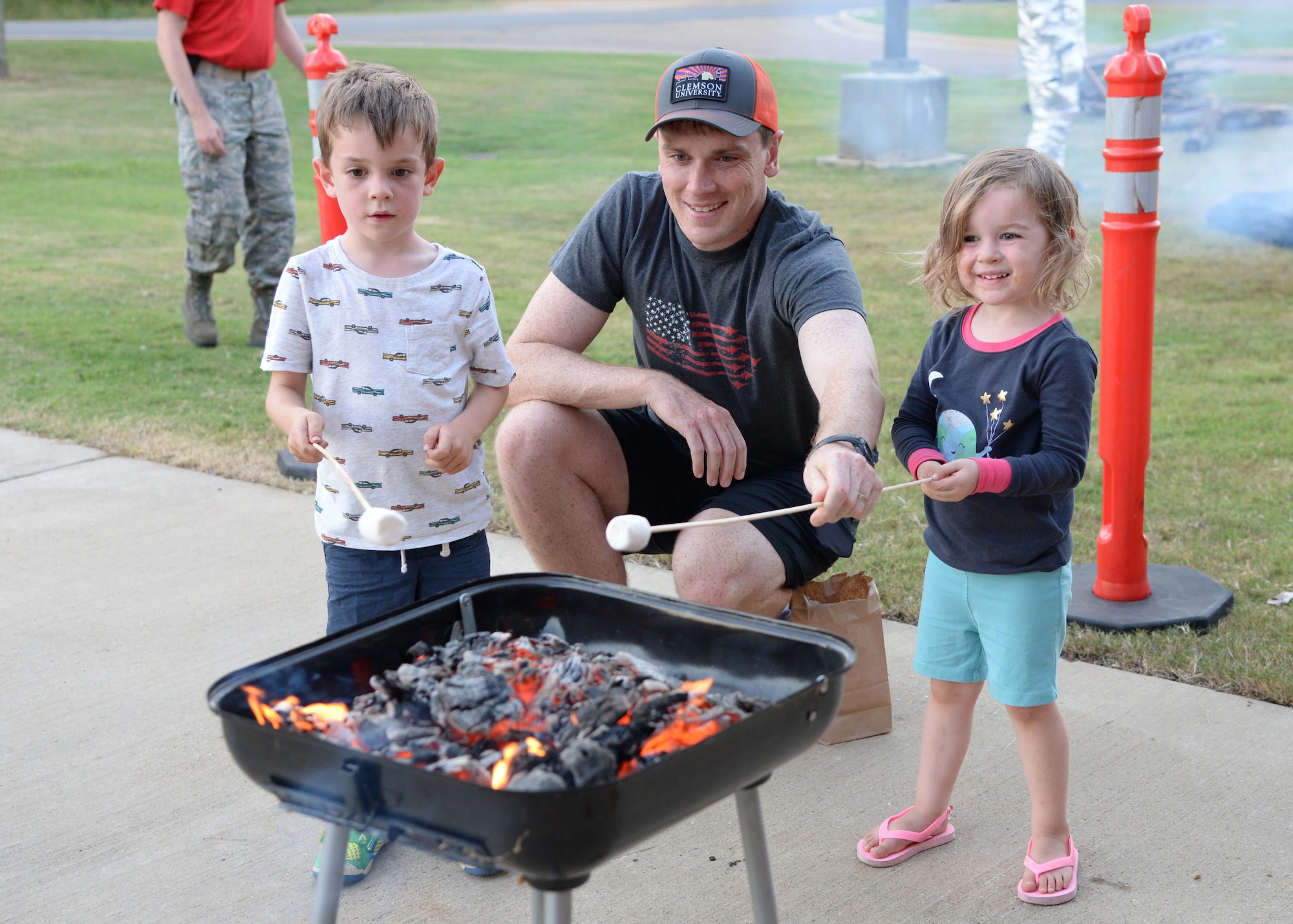 Capt. Zachary Shuler, 14th Operations Group Standards and Evaluation, and his two children, Grady and Paige, roast marshmallows Sept. 29, 2017, on Columbus Air Force Base, Mississippi. The Columbus Fire Department hosted multiple family activities in honor of Fire Prevention Week Sept. 25-30. (U.S. Air Force photo by Airman 1st Class Beaux Hebert)