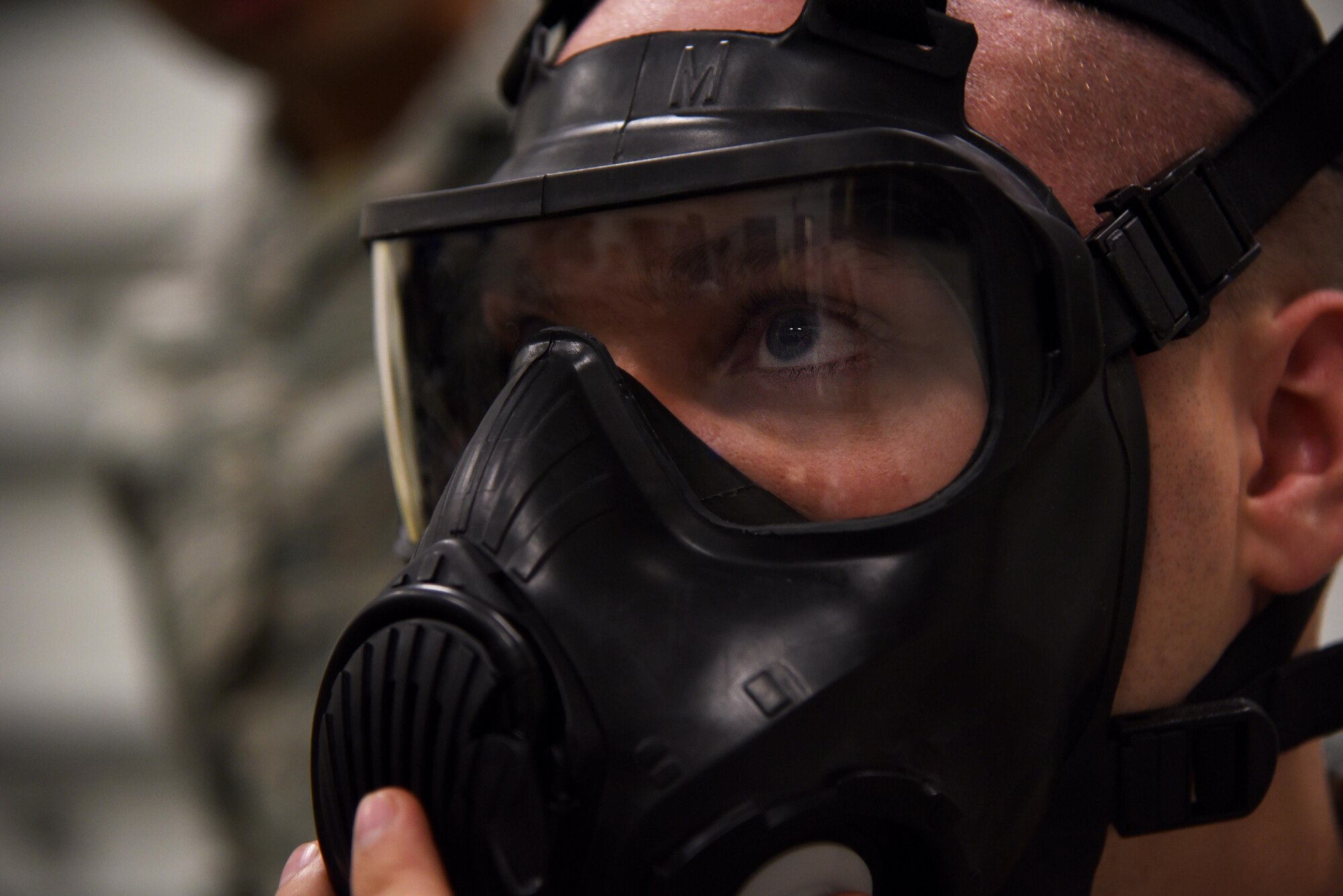 Senior Airman Brett Simmons, 22nd Logistics Readiness Squadron supply journeyman, checks his M50 gas mask for a proper fit during Chemical, Biological, Radiological and Nuclear Survival Skills Training Oct. 3, 2017, at McConnell Air Force Base, Kansas. During the training, Airmen learned protective actions before, during and after an attack, contamination avoidance procedures and how to wear protective gear correctly.