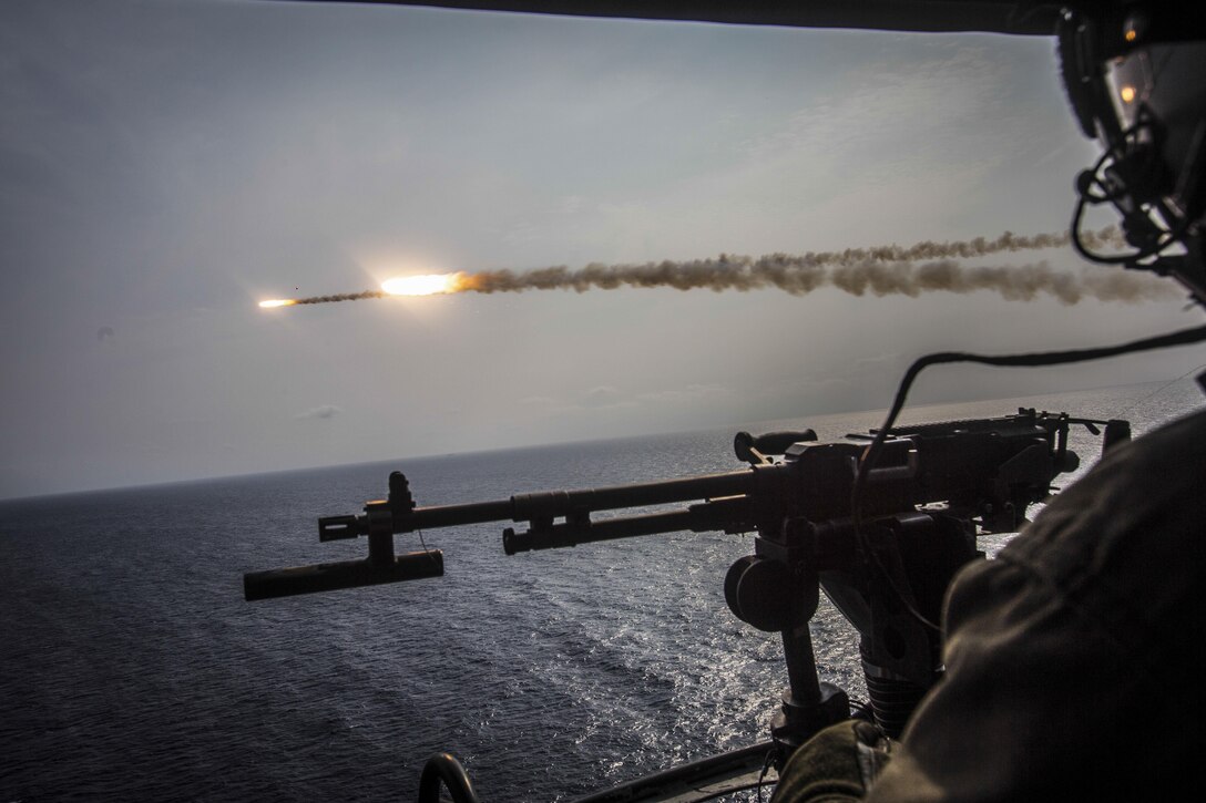 Two missiles fly over the ocean.
