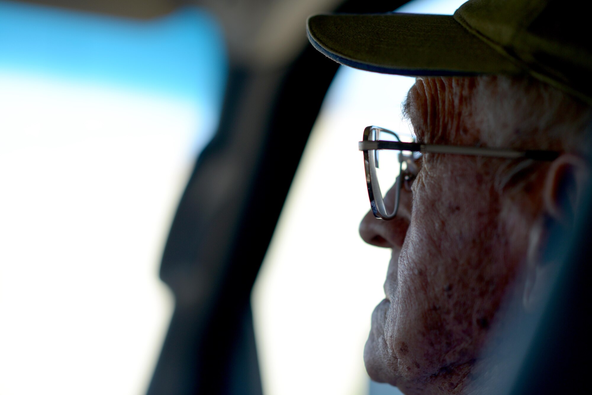 Manuel Martinez, a World War II veteran, looks through a car window during a tour at Luke Air Force Base, Ariz., Oct. 2, 2017. Martinez explained his return to Luke AFB as “coming into a new world.” (U.S. Air Force photo by Senior Airman Devante Williams)