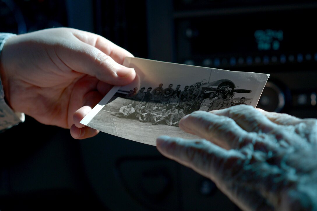 Manuel Martinez, a World War II veteran, shows an Airman assigned to the 56th Fighter Wing his platoon photo at Luke Air Force Base, Ariz., Oct. 2, 2017. Martinez was stationed at Luke in 1941 as a typist and infantryman and also helped out training cadet pilots. (U.S. Air Force photo by Senior Airman Devante Williams)