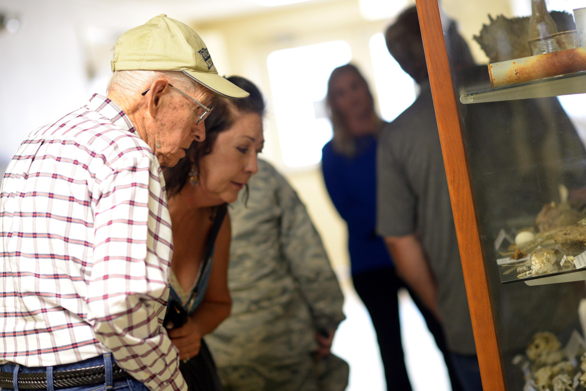 Manuel Martinez, a World War II veteran, and his family view artifacts from Gila Bend Air Force Auxiliary Field during a tour of the 56th Range Management Office at Luke Air Force Base, Ariz., Oct. 2, 2017. Martinez spent the morning reminiscing about his time at the base decades ago and learned about how the Air Force runs today. (U.S. Air Force