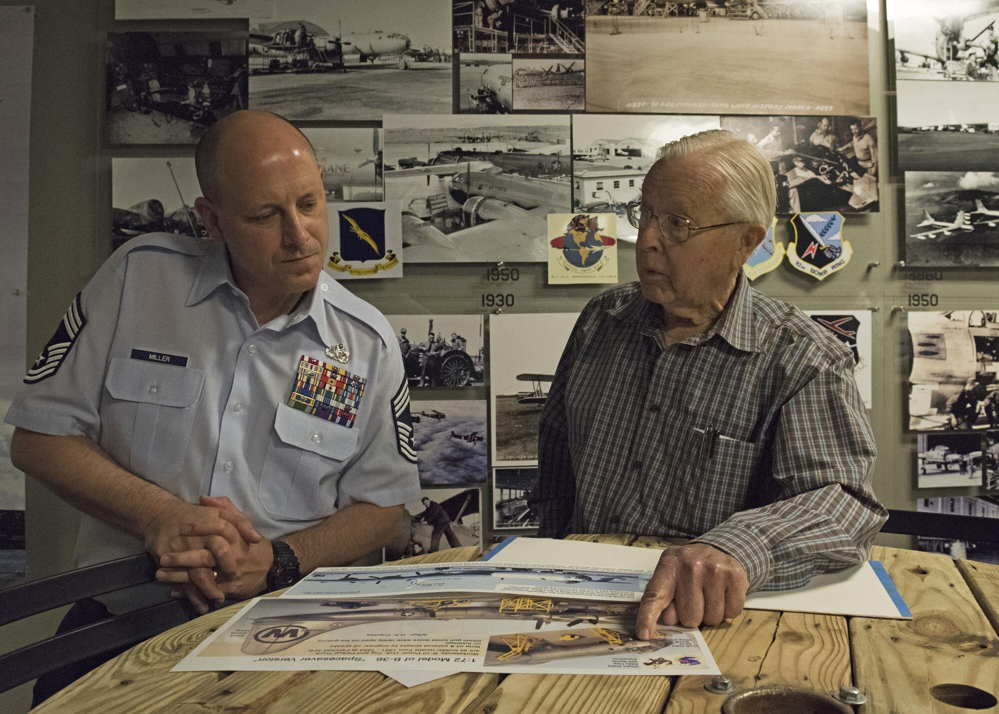 George Prentiss, a Korean War and Air Force veteran, discusses maintenance history with Chief Master Sgt. Christopher Miller, 92nd Maintenance Squadron superintendent, during a base tour at Fairchild Air Force Base, September 29, 2017. Prentiss joined the Air Force in 1952 as a piston jet maintainer and was stationed at Fairchild for four years. (U.S. Air Force photo by Airman 1st Class Jesenia Landaverde)