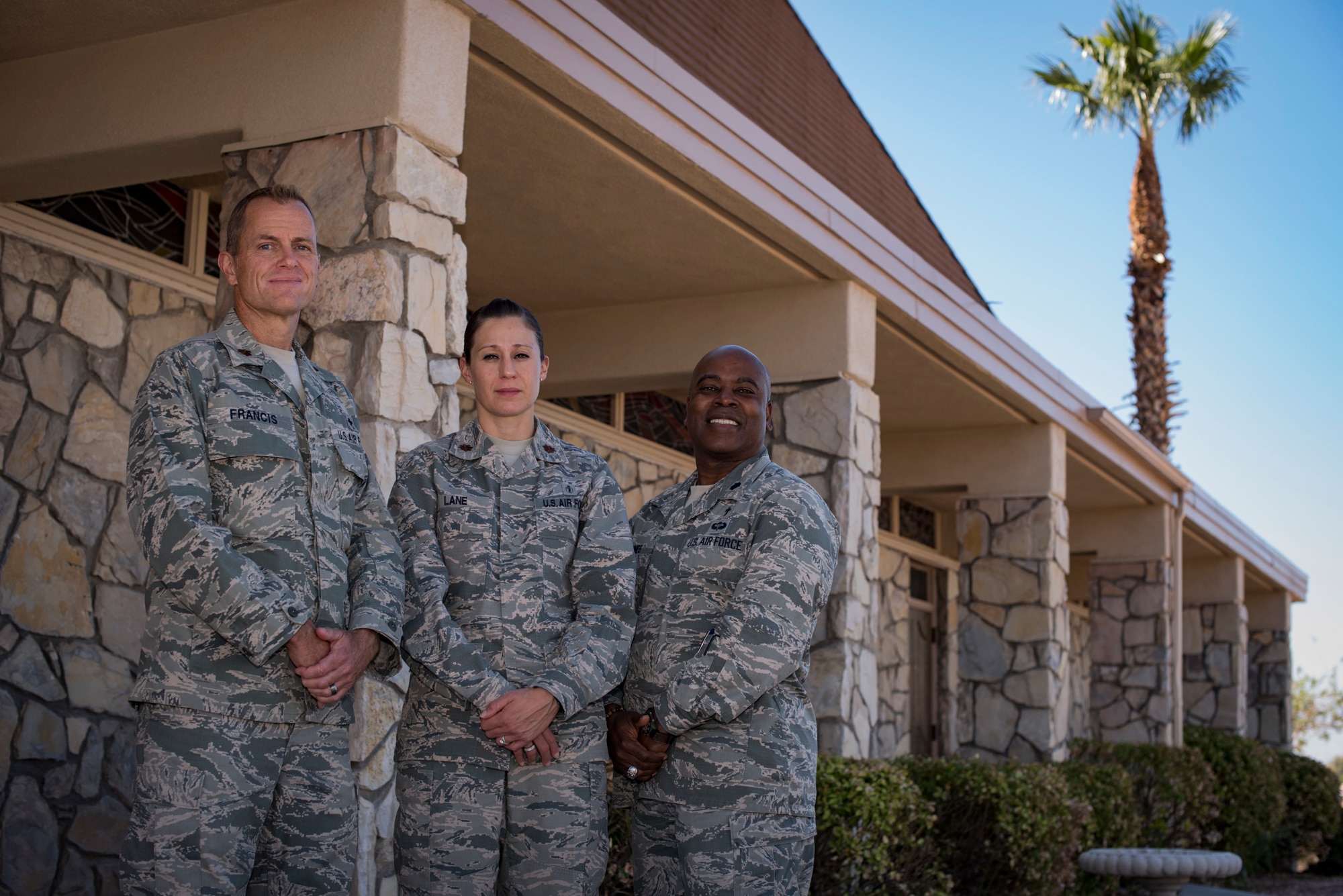 Maj. Kelvin Francis, 99th Air Base Wing chaplain, Maj. Kimberly Lane, 99th Medical Operations Squadron clinical social worker, and Lt. Col. Dwayne Jones, 99th Air Base Wing chaplain, stand in front of the base chapel at Nellis Air Force Base, Nev., Oct. 5, 2017. They are part of the Nellis Disaster Mental Health team that provides services to anyone affected by the recent Las Vegas shooting. (U.S. Air Force photo by Airman 1st Class Andrew D. Sarver/Released)