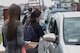 Kei Ri, Family Advocacy domestic abuse victim advocate, hands out cards and purple ribbons for Domestic Violence Awareness Month, Oct. 3, 2017, at Yokota Air Base, Japan.