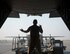 U.S. Air Force Tech. Sgt. Ronald Toia, loadmaster with the 746th Expeditionary Airlift Squadron, marshals a K-loader to a C-130 Hercules at Al Udeid Air Base, Qatar, Oct. 3, 2017.