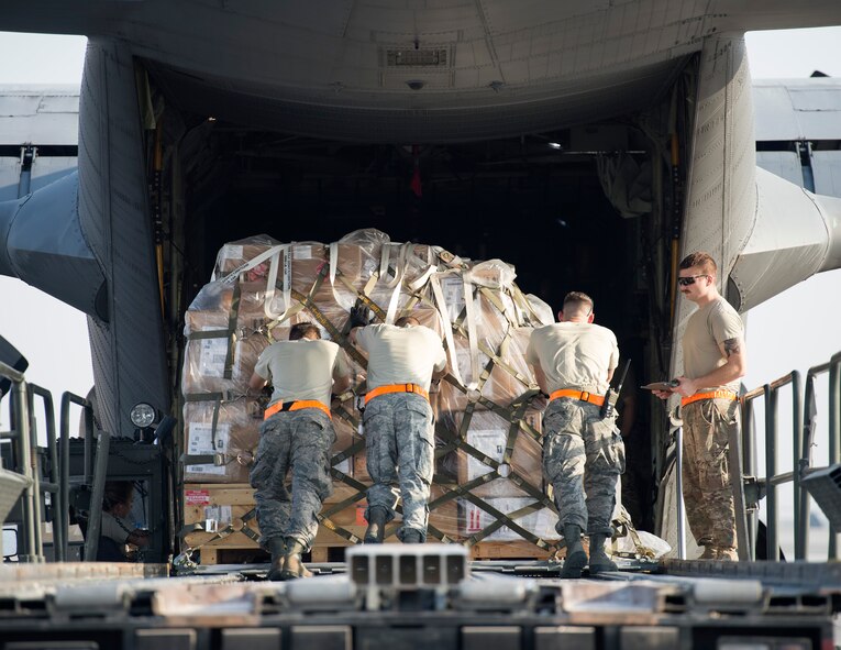 U.S. Air Force air transport specialists with the 8th Expeditionary Air Mobility Squadron, push cargo onto a C-130 Hercules assigned to the 746th Expeditionary Airlift Squadron at Al Udeid Air Base, Qatar, Oct. 3, 2017.