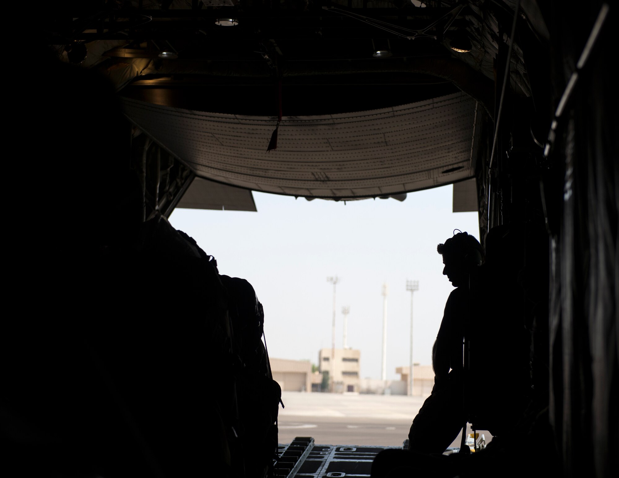 U.S. Air Force Tech. Sgt. Ronald Toia, loadmaster with the 746th Expeditionary Airlift Squadron, waits to close the cargo bay doors on a C-130 Hercules at Al Dhafra Air Base, United Arab Emirates, Oct. 3, 2017.
