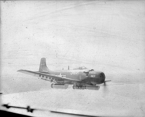 IMAGE: 03/23/1955
AVIATION HISTORY: Navy Plane #357 in flight, carrying ammunition.