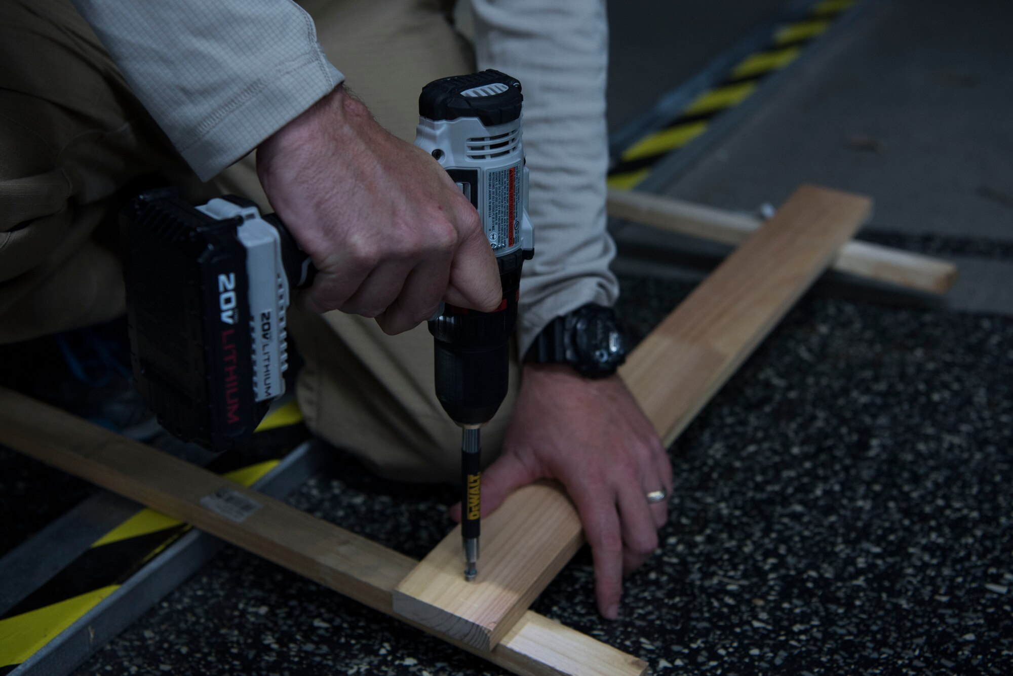 U.S. Air Force Tech. Sgt. Daniel McDermott (right), 435th Construction and Training Squadron transportation flight superintendent, screws a nail into a wall stand being used for a Halloween haunted house at Ramstein Air Base, Germany, Oct. 5, 2017. The haunted house is being constructed hosted by members of the 435th Construction and Training Squadron, 1st Combat Communications Squadron, 1st Air and Space Communications Operations Squadron and 435th Contingency Response Squadron, for the base populace to enjoy.