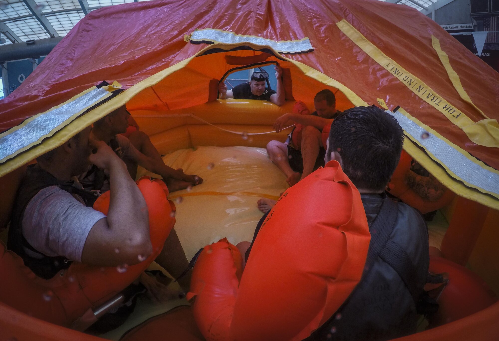 A 58th Operations Support Squadron aircrew flight equipment technician teaches basic water survival skills to members of the 377th Force Support Squadron and the 150th Special Operations Wing at Kirtland Air Force base, New Mexico, September 27, 2017.  The Airmen learned the importance of staying calm in high stress situations that can range from escaping a submerged aircraft to sharing a life raft with up to 20 other people.  (U.S. Air Force photo by Airman 1st Class Andrew D. Sarver)