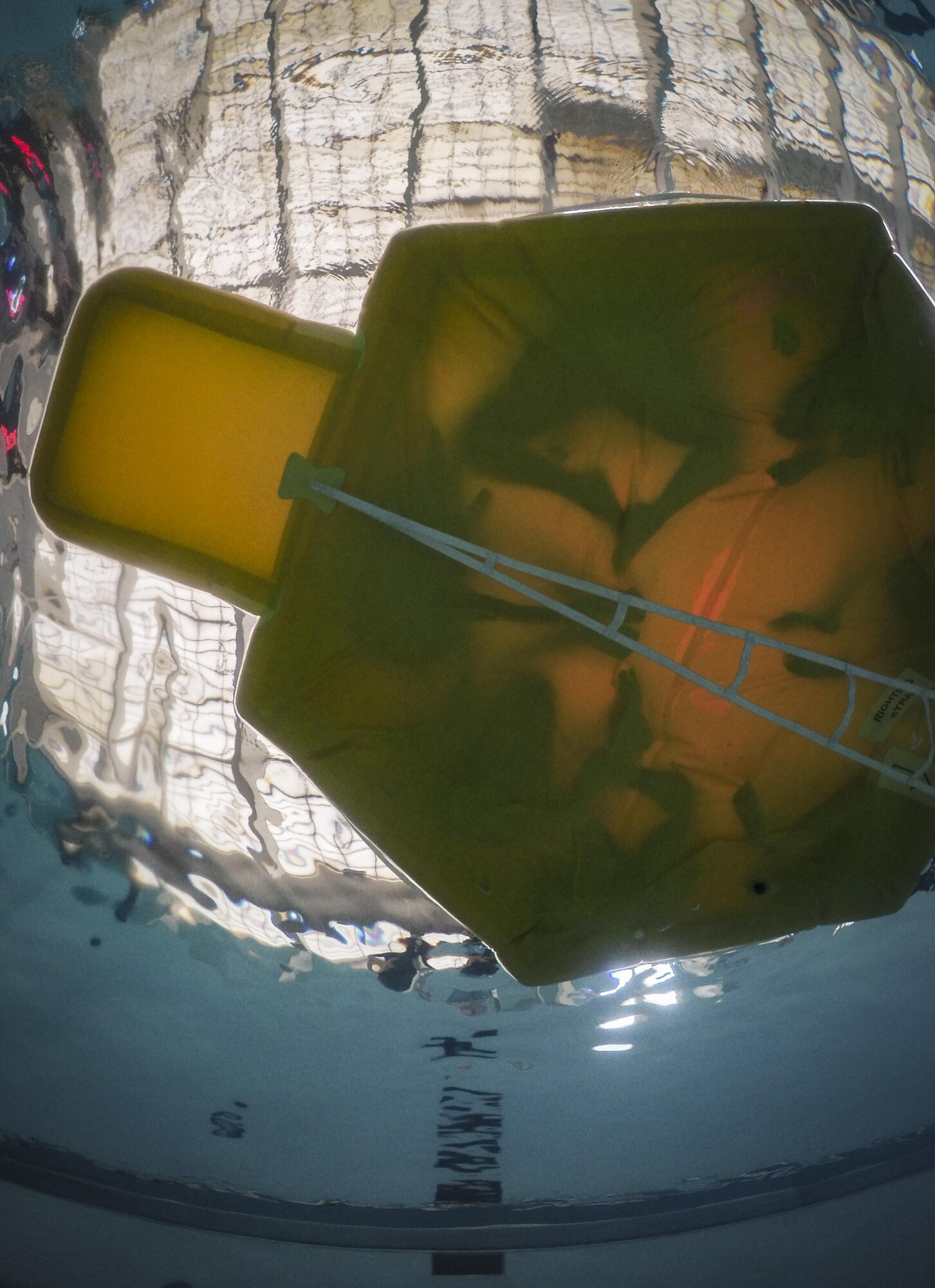 Members of the 377th Force Support Squadron and 150th Special Operations Wing sit on a life raft during a water survival training exercise at Kirtland Air Force Base, New Mexico, September 27, 2017.  The members learned about the importance of maintaining composure during high stress situations.  (U.S. Air Force photo by Airman 1st Class Andrew D. Sarver)