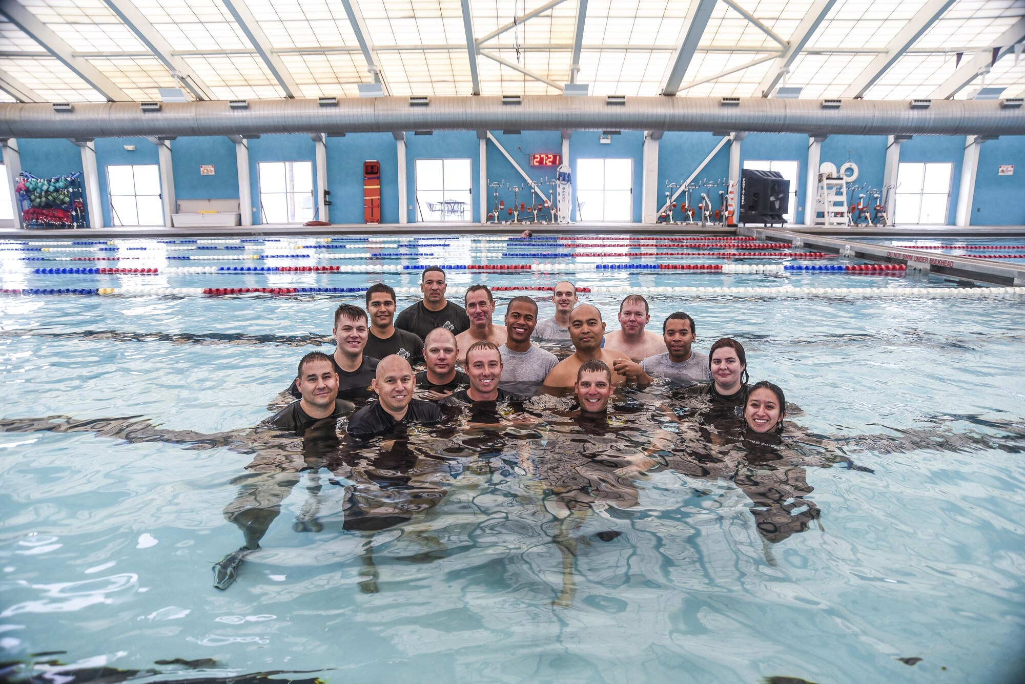 Instructors from the 58th Operations Support Squadron gather with participants for a group photo after completing all portions of water survival training..  Airmen from the 377th Force Support Squadron and 150th Special Operations Wing completed an overturned-aircraft simulation, compressed-air breathing exercises and various parachute escape exercises.