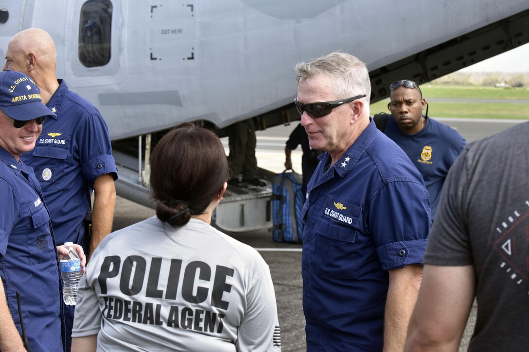 Coast Guard Rear Adm. Peter J. Brown, commander of the Coast Guard Seventh District, is greeted during a visit at Coast Guard Air Station Borinquen, Puerto Rico.