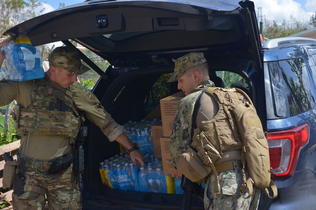 Members of Coast Guard Tactical Law Enforcement Teams South and Port Security Unit 307 bring supplies to victims of Hurricane Maria in Bayamon, Puerto Rico.