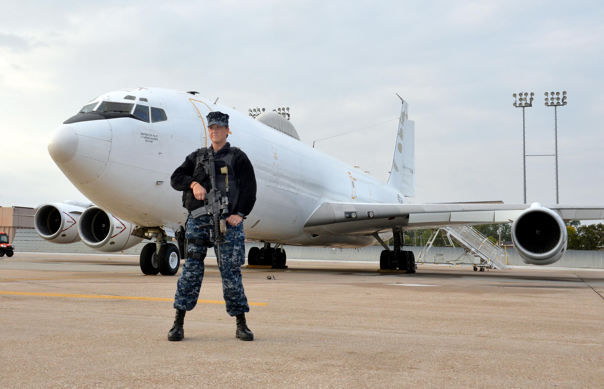 U.S. Navy Seaman Sarah Askew, 55th Security Forces master at arms, stands watch near an E-6 Mercury on the flightline Oct. 3.